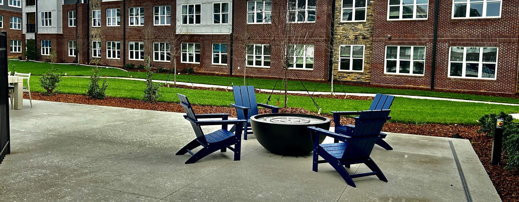 a group of blue chairs in front of a brick building